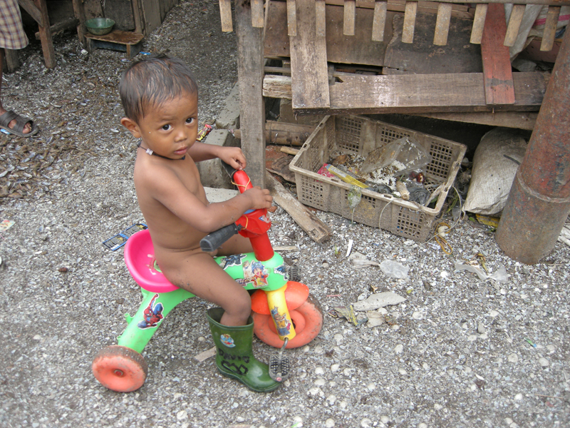 Boy on bike in slum