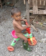 Boy on bike in slum